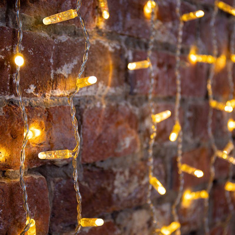 Гирлянда светодиодная "Светодиодный Дождь" 2х1.5м 300LED тепл. бел. 65Вт 230В IP65 эффект мерцания провод силикон. прозр. (нужен шнур питания 303-500-1) Neon-Night 235-316